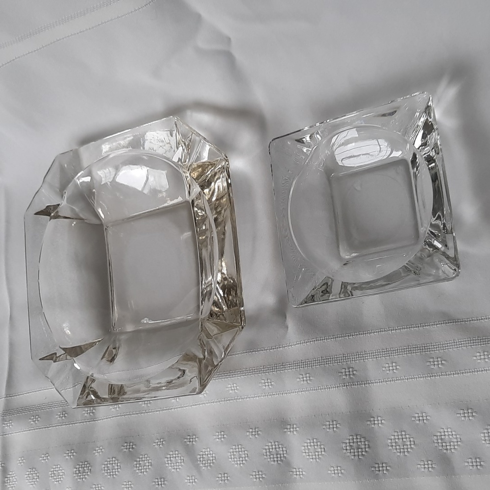 A Set of Two Vintage clear glass ashtrays large and small.